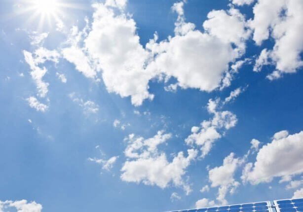 A blue sky with some clouds in the background