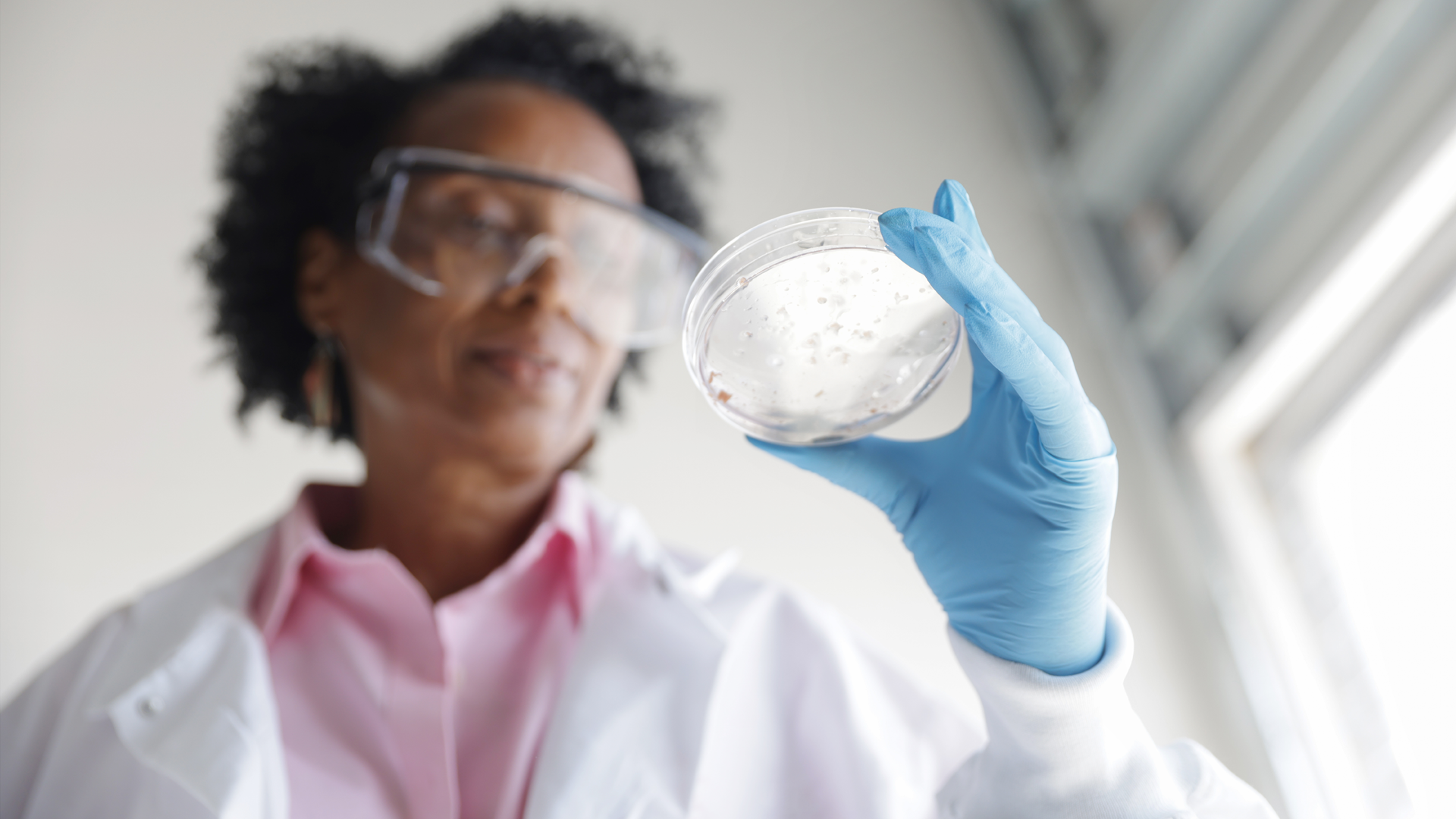 A female scientist conducting research in a laboratory, focusing on orphan drugs for rare diseases