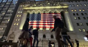 People pass the New York Stock Exchange in New York's Financial District on Tuesday, Nov. 5, 2024. (AP Photo/Peter Morgan)