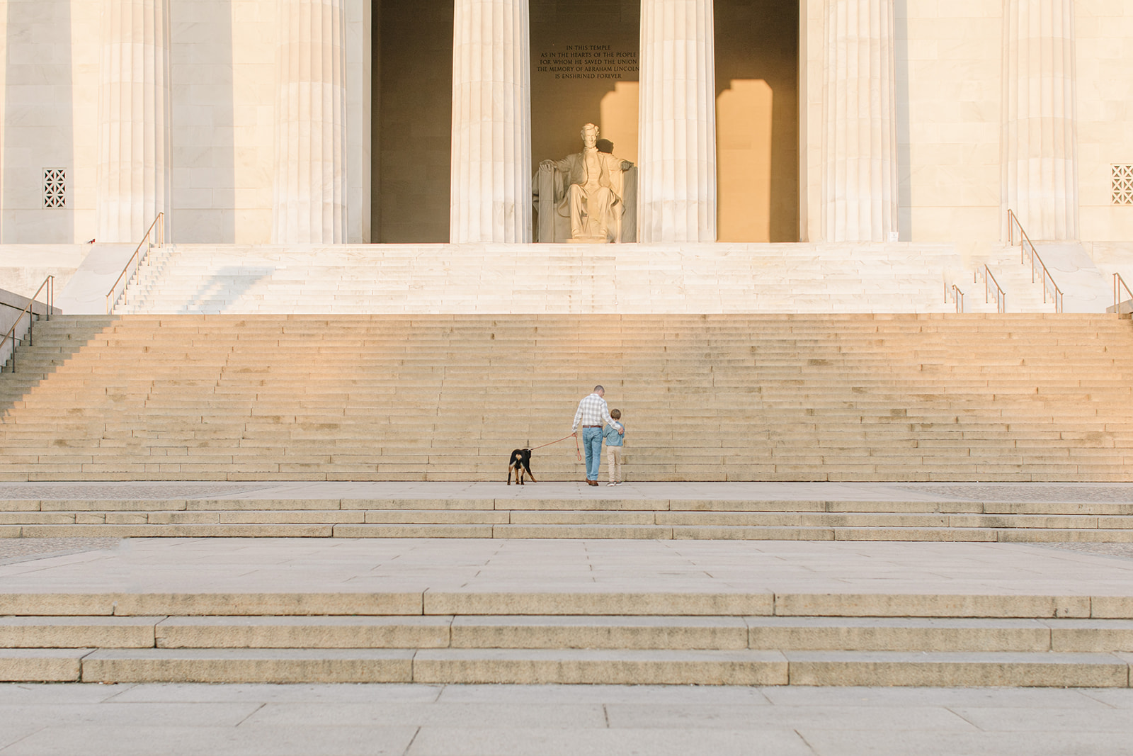 family walking up the steps of a monument