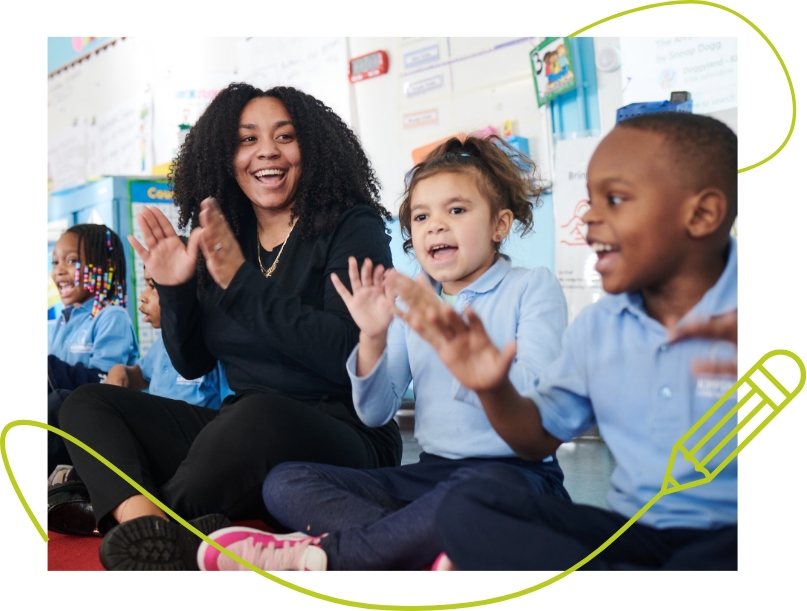 teacher in classroom smiling with children