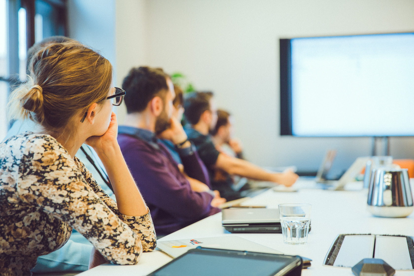 Team in conference room and attending presentation.