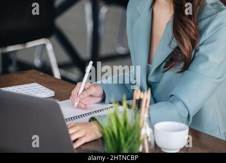 Investment concepts, businesswomen use document and computers to analyze stock markets, quantitative data collection, financial statement analysis Stock Photo