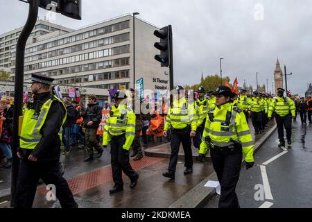 Male and female police officers from the Metropolitan force, policing a peaceful demonstration against the Tory governments cost of living crisis. Stock Photo