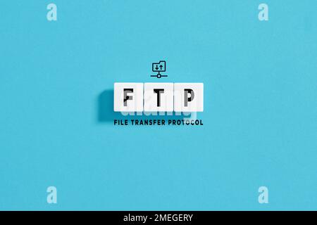 White letter blocks on blue background with the acronym FTP File Transfer Protocol. Internet Technologies concept on blue background. Stock Photo