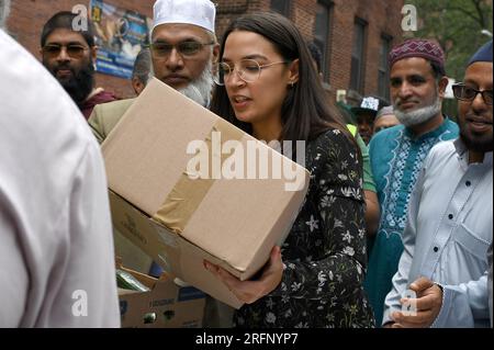 New York, USA. 04th Aug, 2023. Rep. Alexandria Ocasio-Cortez helps distribute food to people suffering from food insecurities at the Parkchester Islamic Center in the New York City borough of the Bronx, NY, August 4, 2023. Rep. Ocasio-Cortez outlined her efforts to increase access to halal and kosher food in the 2023 federal ‘Farm bill', as Muslim and Jewish families struggle to afford food that meets their faith's dietary guidelines. (Photo by Anthony Behar/Sipa USA) Credit: Sipa USA/Alamy Live News Stock Photo