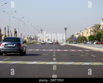 Cairo, Egypt, December 14 2022: A road sign on the asphalt instructing vehicles to slow down, pedestrian crossing ahead. Sign indicating crossing ahea Stock Photo