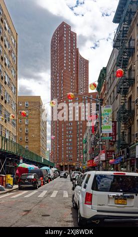 NYC Chinatown: Bayard Street, looking east from Elizabeth Street in the heart of Chinatown. Colorful paper lanterns hang above the shop-lined street. Stock Photo