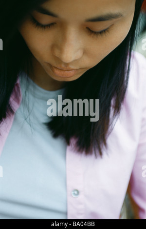 Woman with head down and eyes closed, portrait Stock Photo