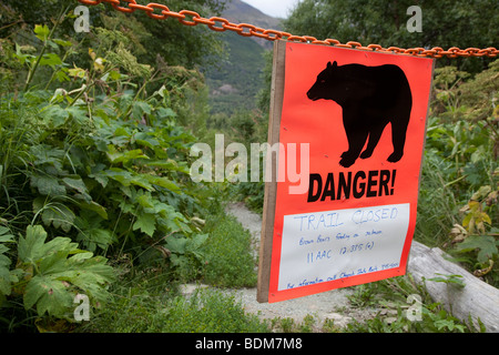 Eagle River, Alaska - A sign warns that a trail in Chugach State Park is closed due to danger from brown bears. Stock Photo