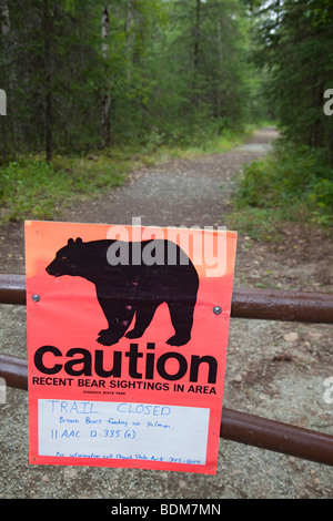 Eagle River, Alaska - A sign warns that a trail in Chugach State Park is closed due to danger from brown bears. Stock Photo