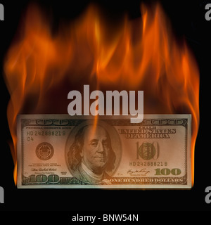 Burning 100 dollar bill Stock Photo