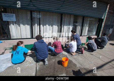 Volunteer teens paint and clean the space of a synagogue located in a mosque Stock Photo