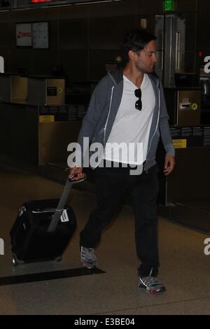 Tobey Maguire hide behind a greeter at Los Angeles International Airport, LAX  Featuring: Tobey Maguire Where: Los Angeles, CA, United States When: 19 Sep 2013 Stock Photo