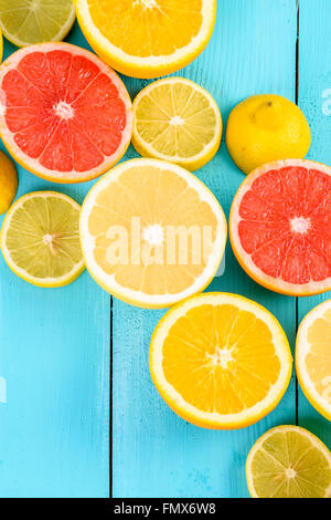 Lemon, Orange, Grapefruit And Lime Citrus Fruit Slices On Turquoise Table Stock Photo