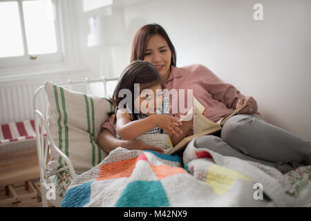 Girl turning page of a story book Stock Photo