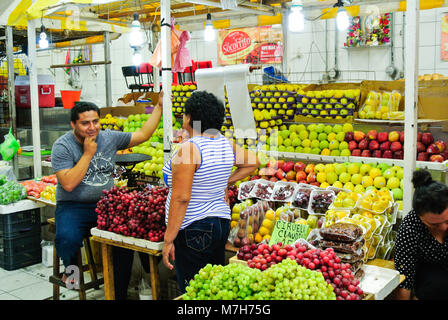 Mexican seller of fruits stand at a local market, Merida, Yucatan, Mexico Stock Photo