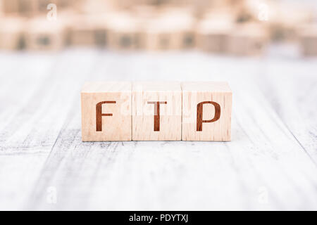 The Word FTP Formed By Wooden Blocks On A White Table Stock Photo