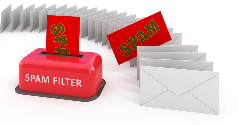 A computer-generated image shows a bright-red box with a slit on the top with a bright-red envelope sticking out. Written on the box in white is, “Spam Filter.” The red piece of mail has the word “Spam” on it, although the “m” is cutoff because it’s inside the slit. To the right is a row of white envelopes lined up like dominos and curving off to the left. One of those envelopes is bright-red and has “Spam” written on it in olive green.