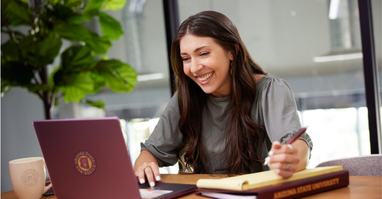 ASU student looking at laptop