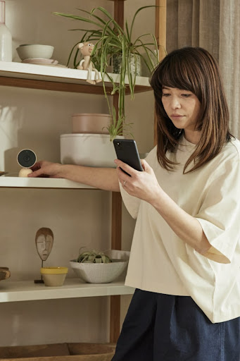 A person using their Pixel phone to check in on their smart home devices.