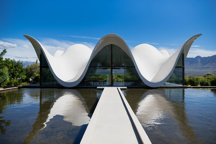 The remarkable Chapel at Bosjes with its distinctive undulating white roof appears to float on a pool of water at the heart of quiet and peaceful Chapel gardens.