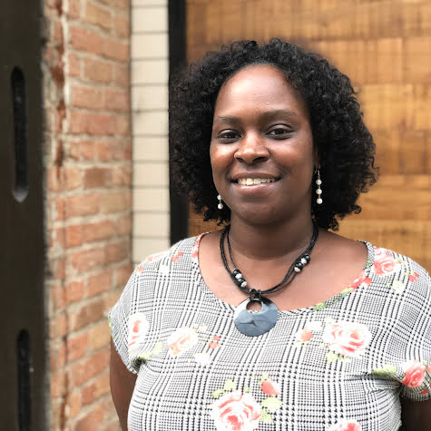 Woman smiling and looking at camera.