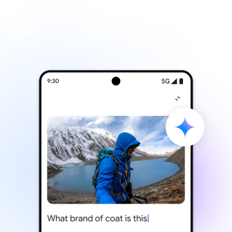 A phone screen showing a person in a coat standing by a  lake, mountains, with text, "What brand of coat is this" below the photo.