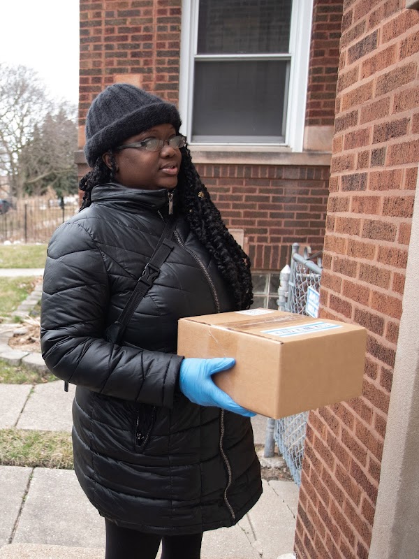 Volunteer dropping off supplies to a senior citizen