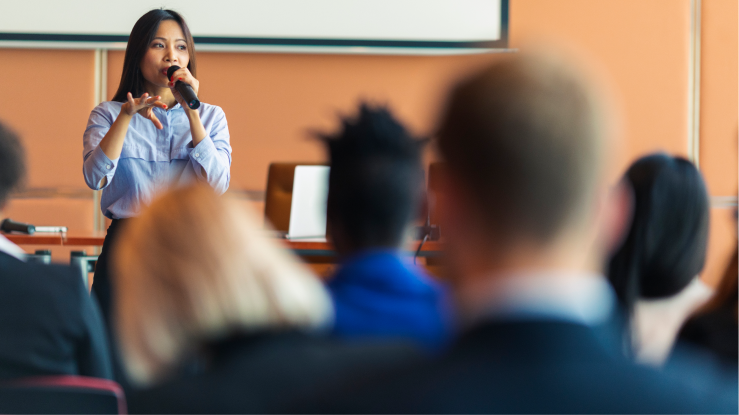 A woman speaking to an audience 