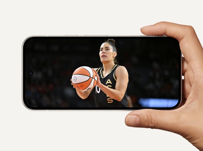 A Pixel 9 turned sideways in landscape mode, showing a women's basketball game on the Actua display.