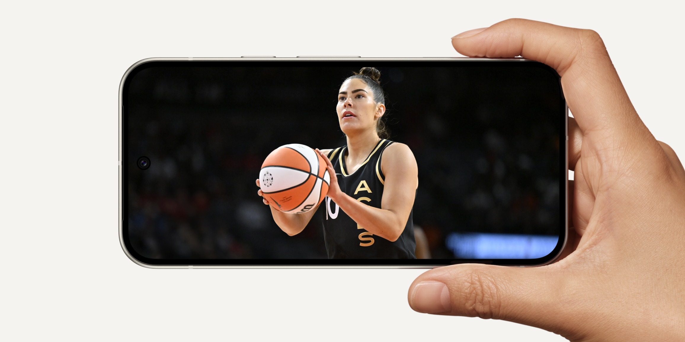 A Pixel 9 turned sideways in landscape mode, showing a women's basketball game on the Actua display.