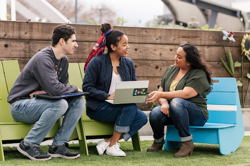 Three Google employees talking outside