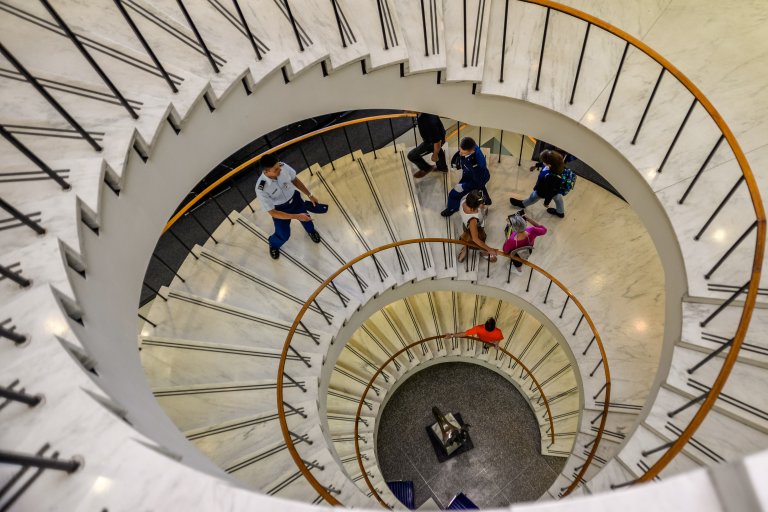 Photo of Cadets on the spiral staircase in McDermott Library