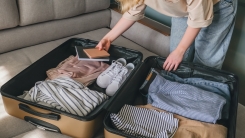 Woman packing suitcase