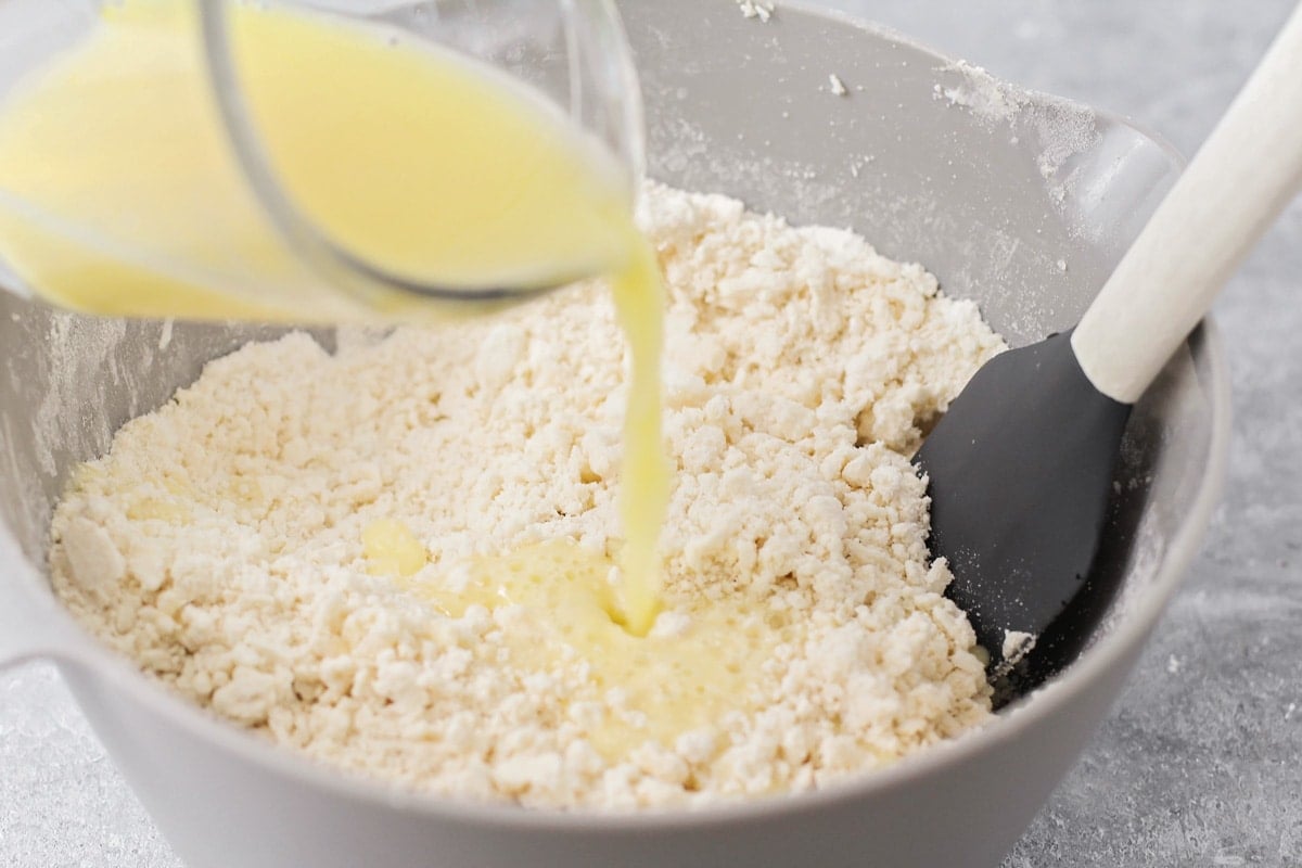 Adding liquid to the flour mixture.