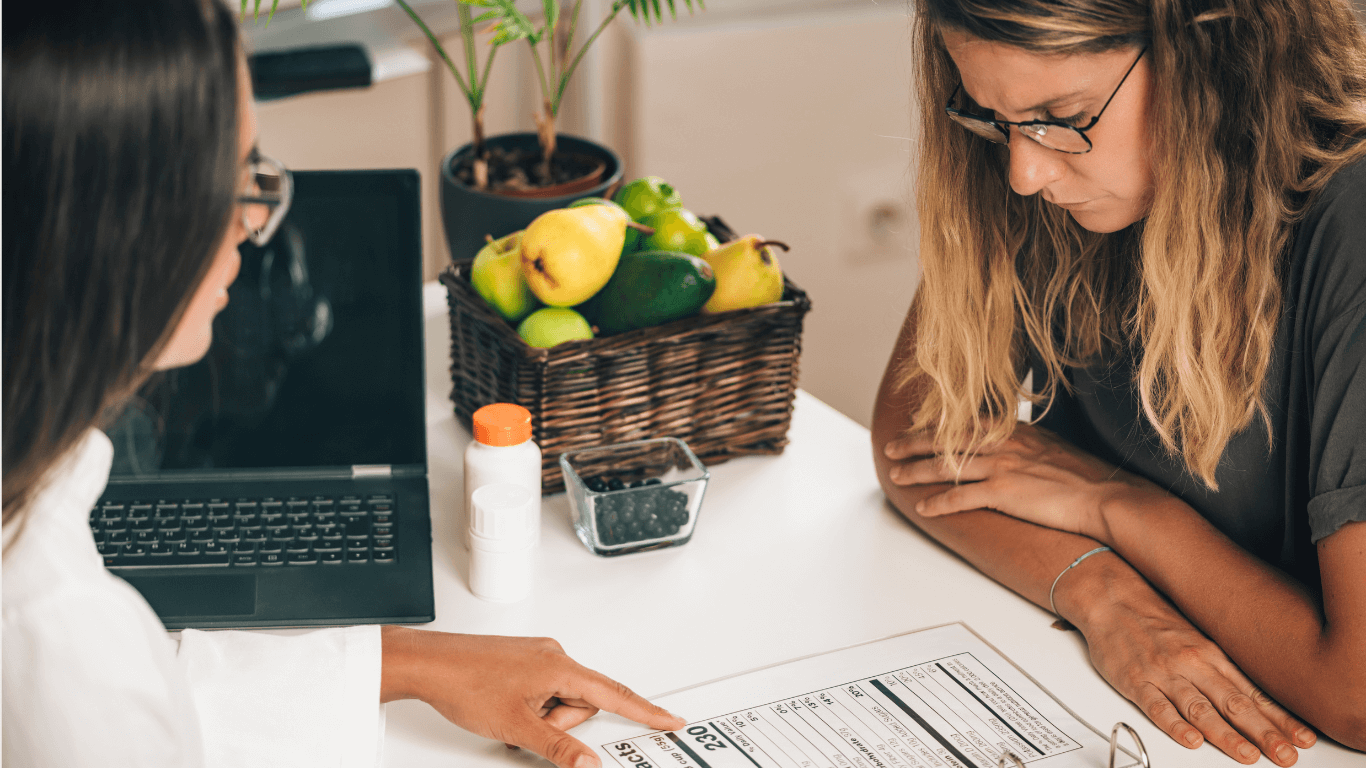 Women pointing to nutrition facts to another woman listening attentively