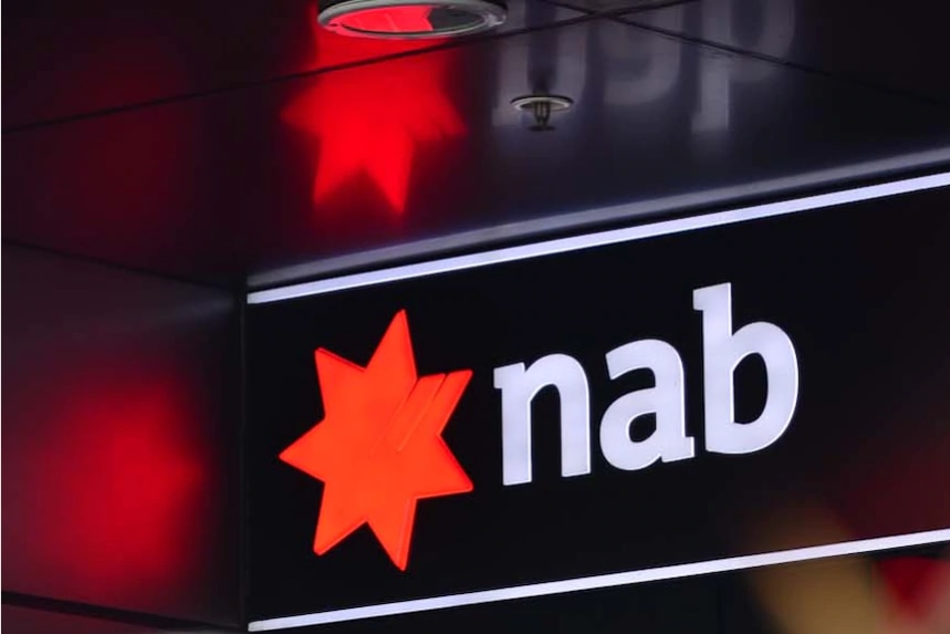 NAB sign with red star logo and 'nab' in white lettering. Red star reflects off corresponding roof and walls.