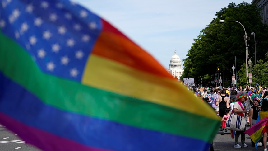 A pride flag before Capitol HIll 