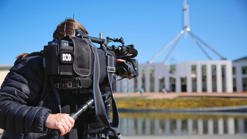 ABC camera operator filming Parliament House