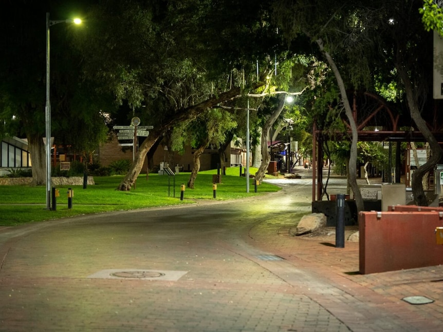 An empty street pictured at night lit up by street lights