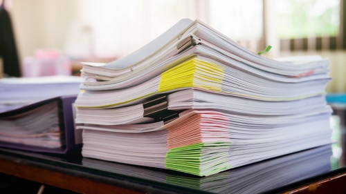 A pile of papers on a desk