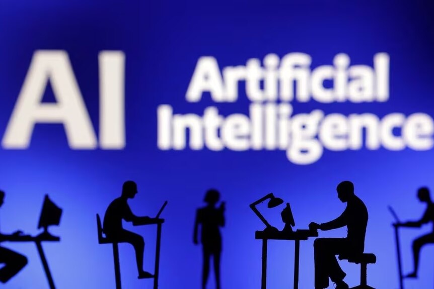 Figurines with computers and smartphones are seen in front of the words "Artificial Intelligence AI" in this illustration.