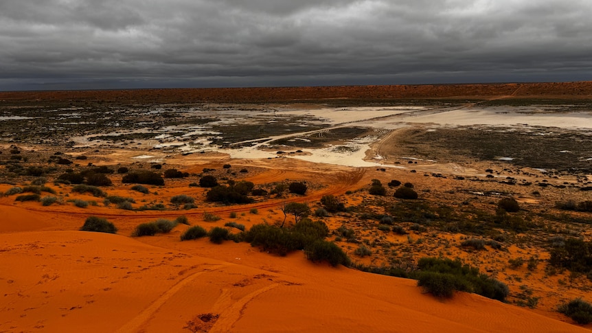 red first sand dunes and muddy claypan