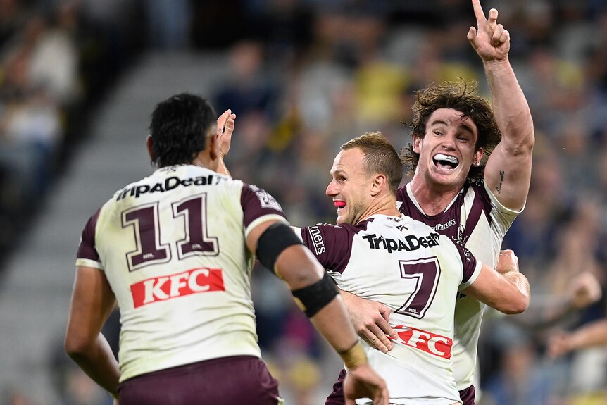 Ethan Bullemor and Haumole Olakau'atu celebrate winning an NRL game with Daly Cherry-Evans.