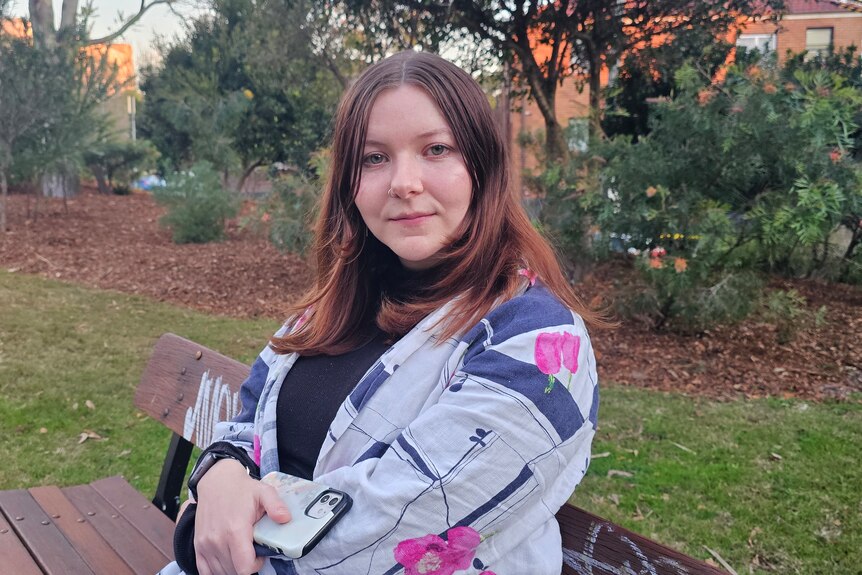 Woman sitting on a park bench.