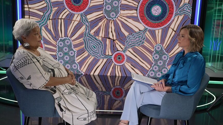 Two women sitting across from each other in an interview.