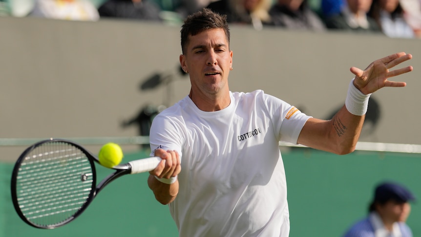 Thanasi Kokkinakis hits a forehand at Wimbledon