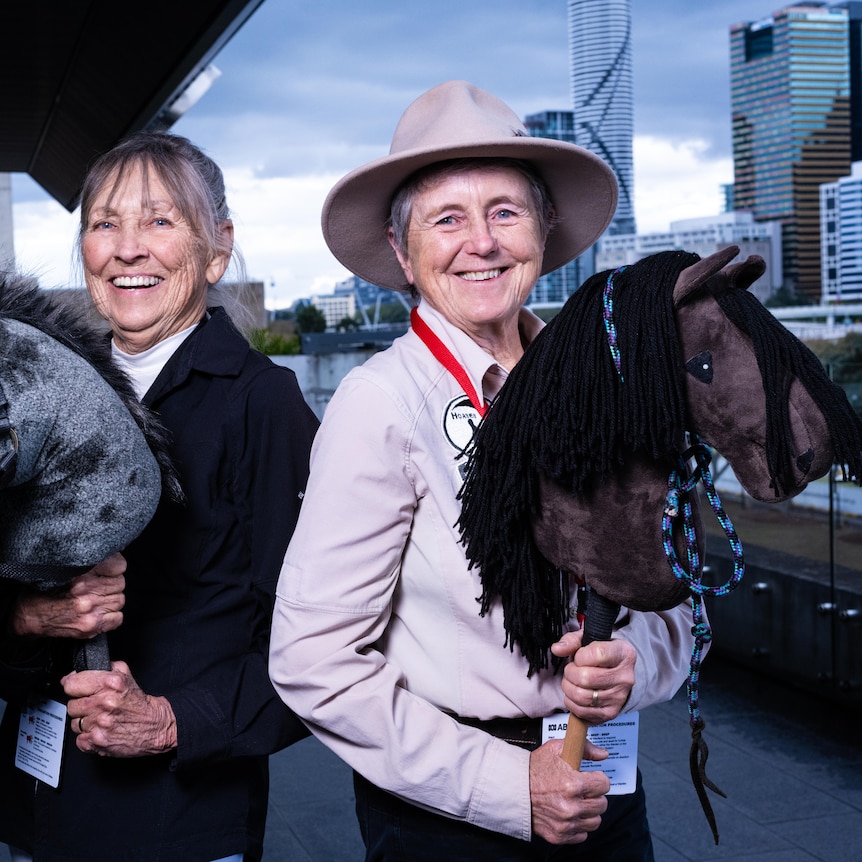 Two elderly women with stick horses