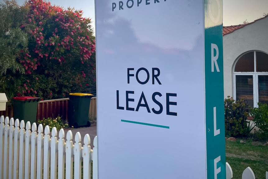 A for lease sign at a picket fence